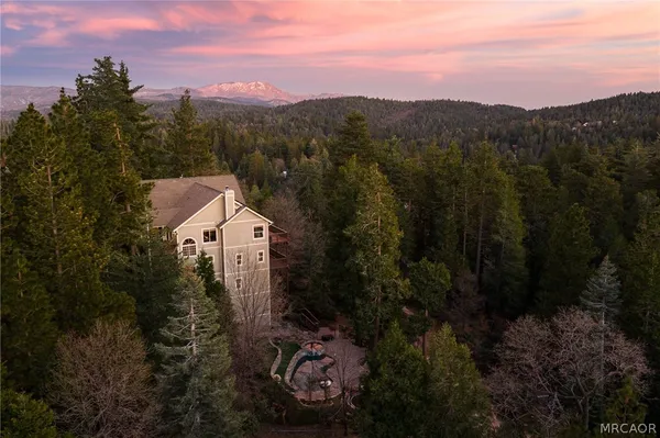 a view of a house with a mountain in the background