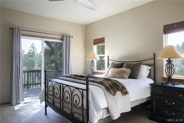 a bedroom with a bed and a lamp next to a window