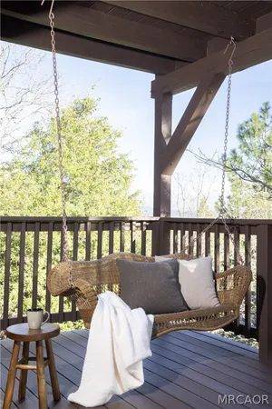 a view of balcony with wooden floor and outdoor seating