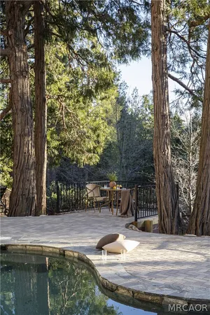 a view of swimming pool with a patio and mountain view
