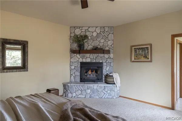 a bedroom with a bed and a fireplace