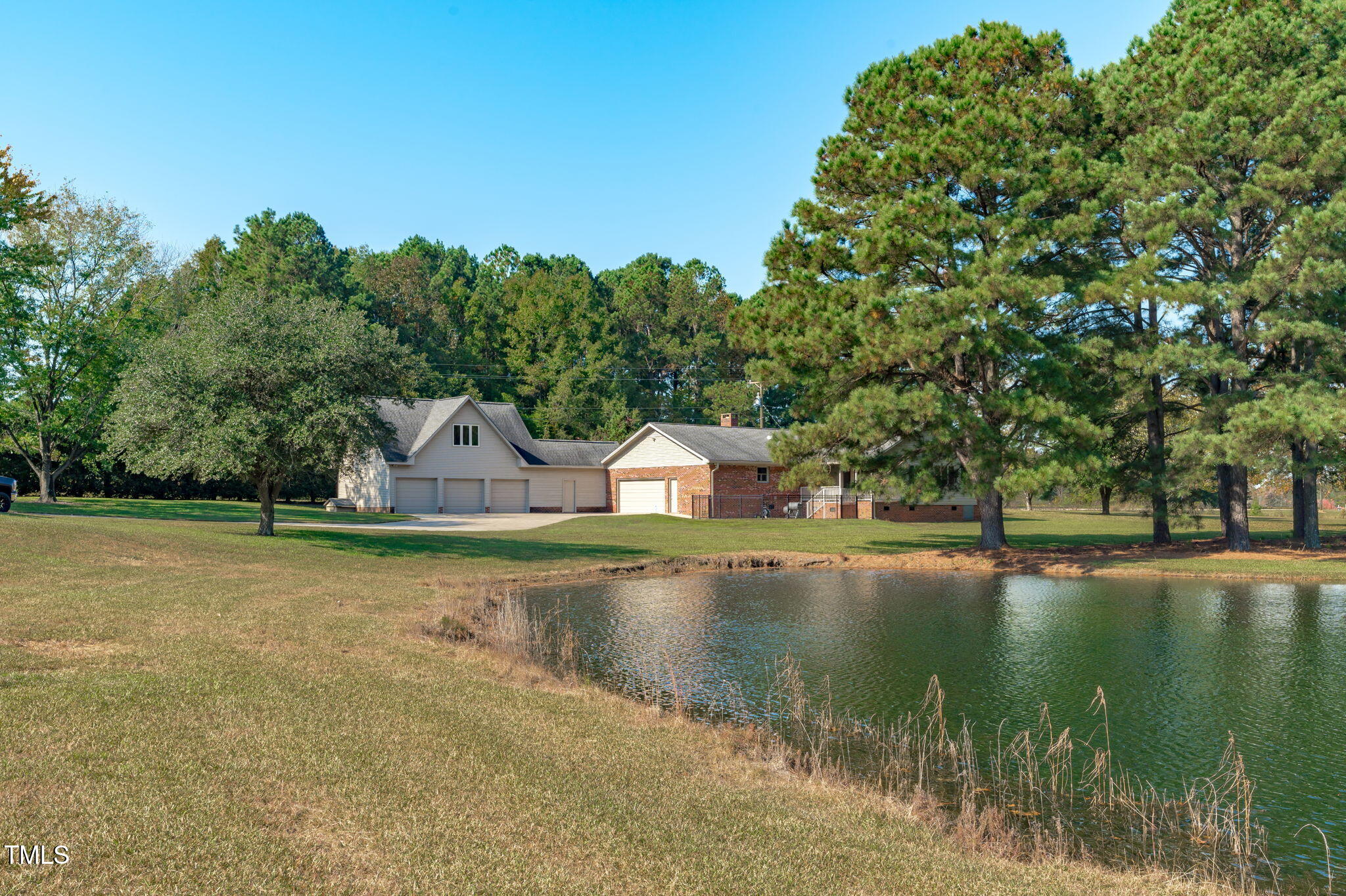 411 Tant Road Zebulon, NC 27597 - Photo 1 of 48 a front view of a house with a yard and lake view