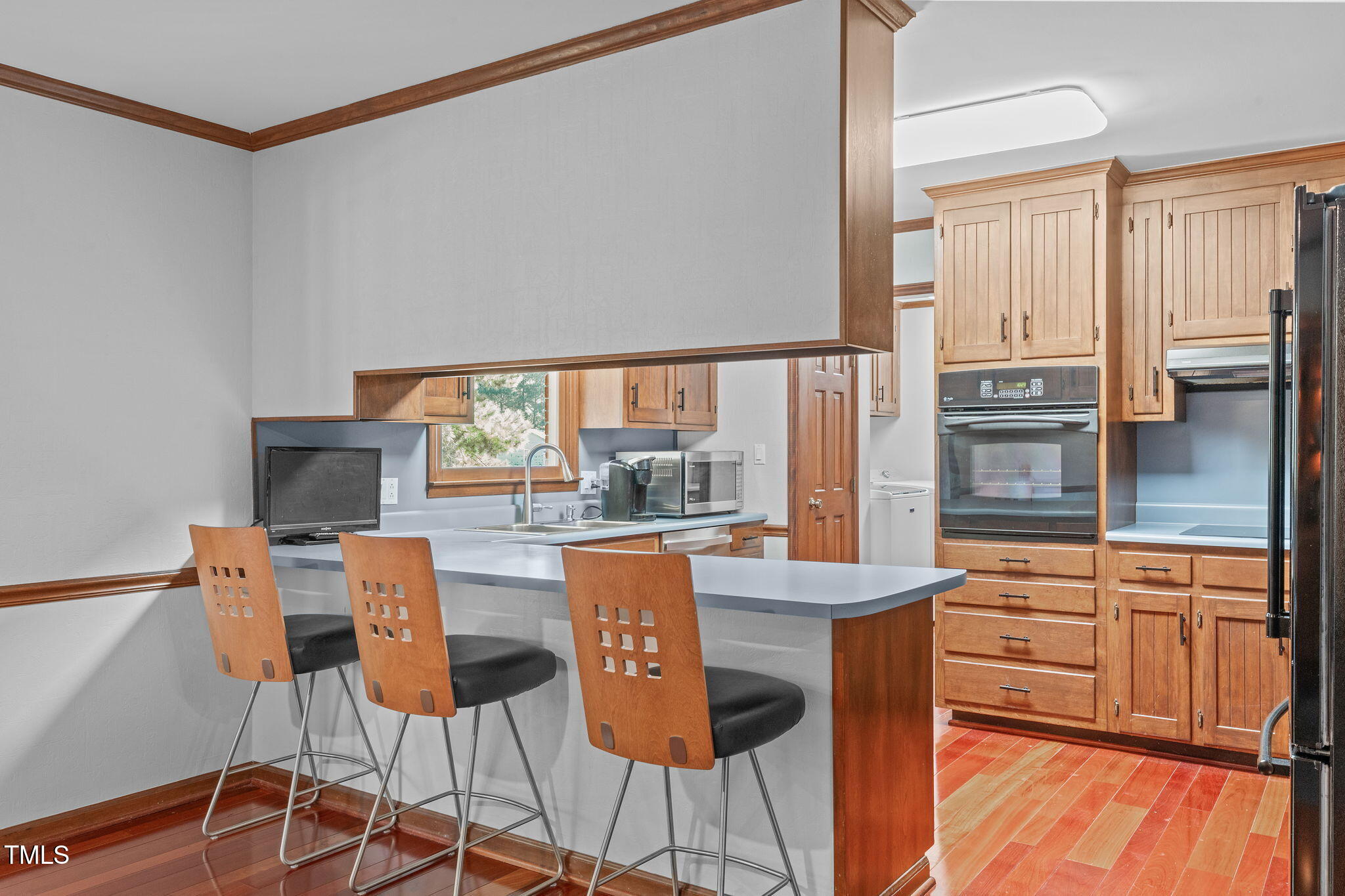 411 Tant Road Zebulon, NC 27597 - Photo 11 of 48 a dining hall with stainless steel appliances granite countertop a stove and a refrigerator