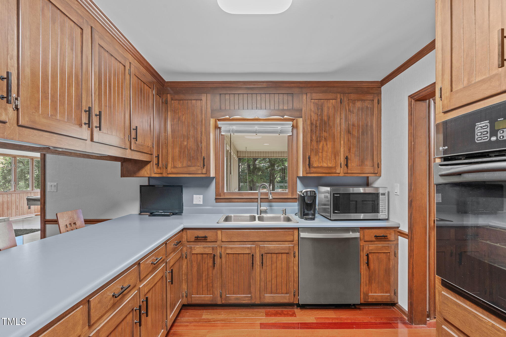 411 Tant Road Zebulon, NC 27597 - Photo 13 of 48 a kitchen with kitchen island granite countertop a sink cabinets and window