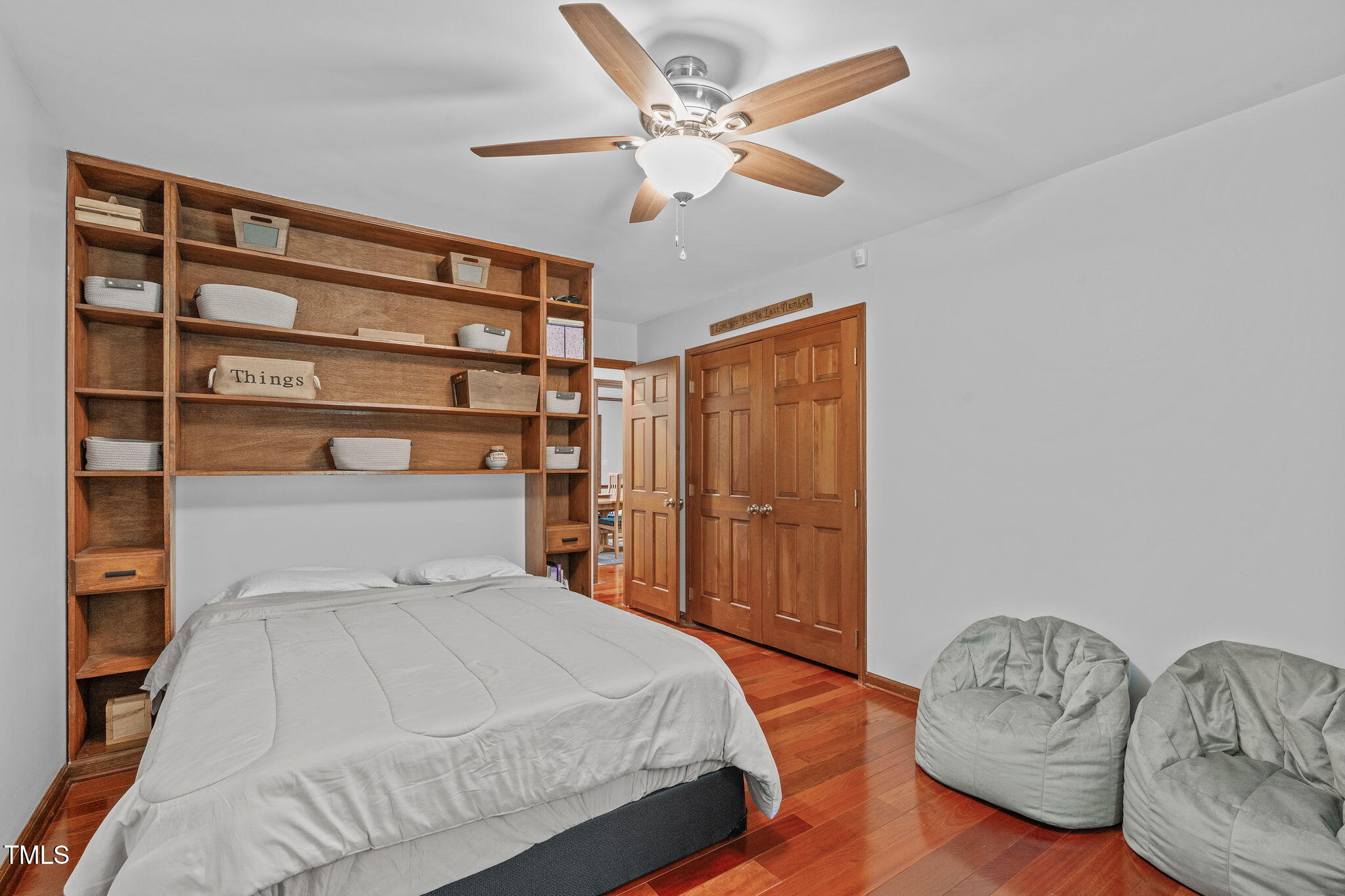 411 Tant Road Zebulon, NC 27597 - Photo 18 of 48 a bedroom with a large bed and a chandelier