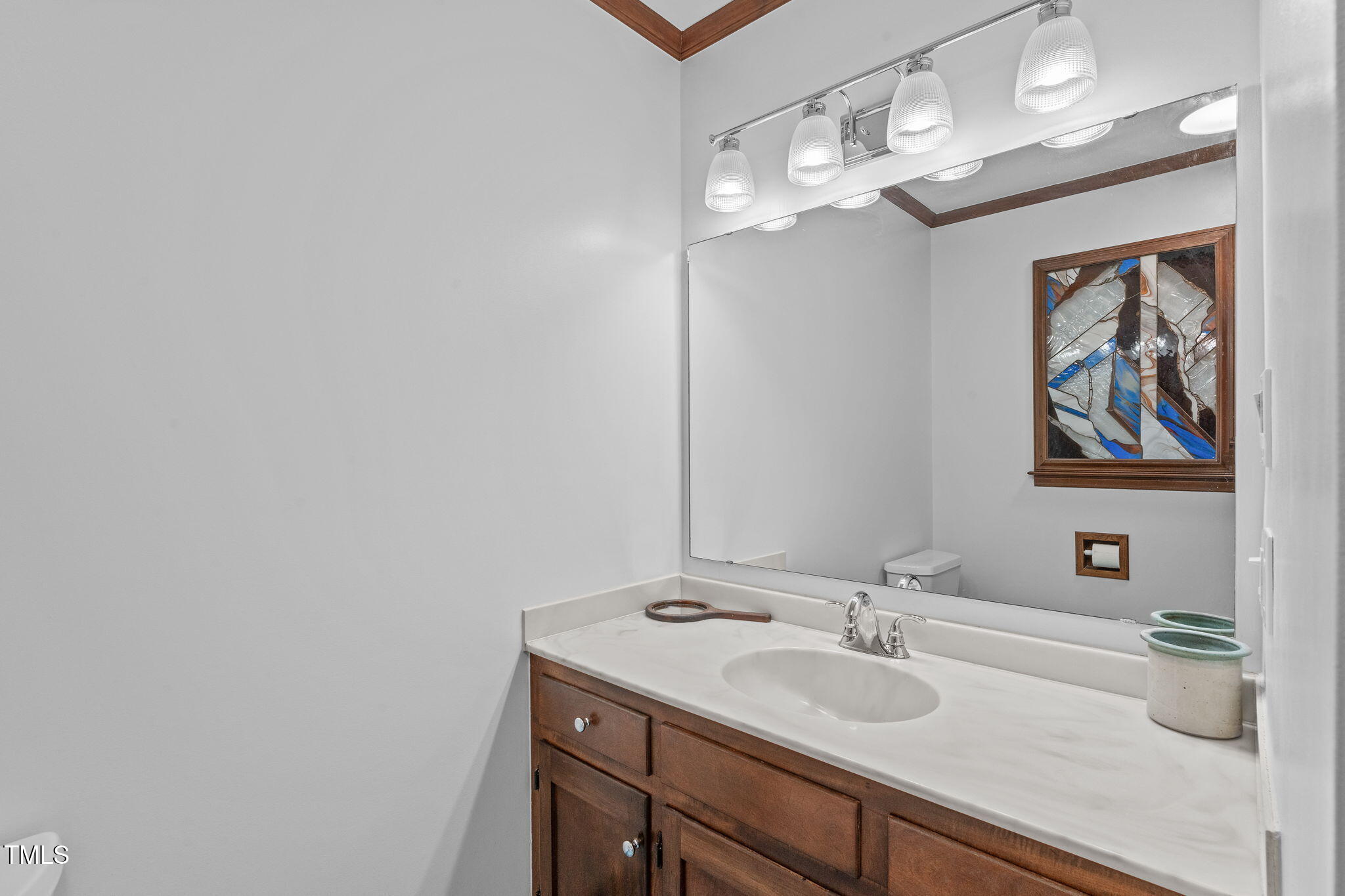 411 Tant Road Zebulon, NC 27597 - Photo 26 of 48 a bathroom with a sink a vanity and a mirror