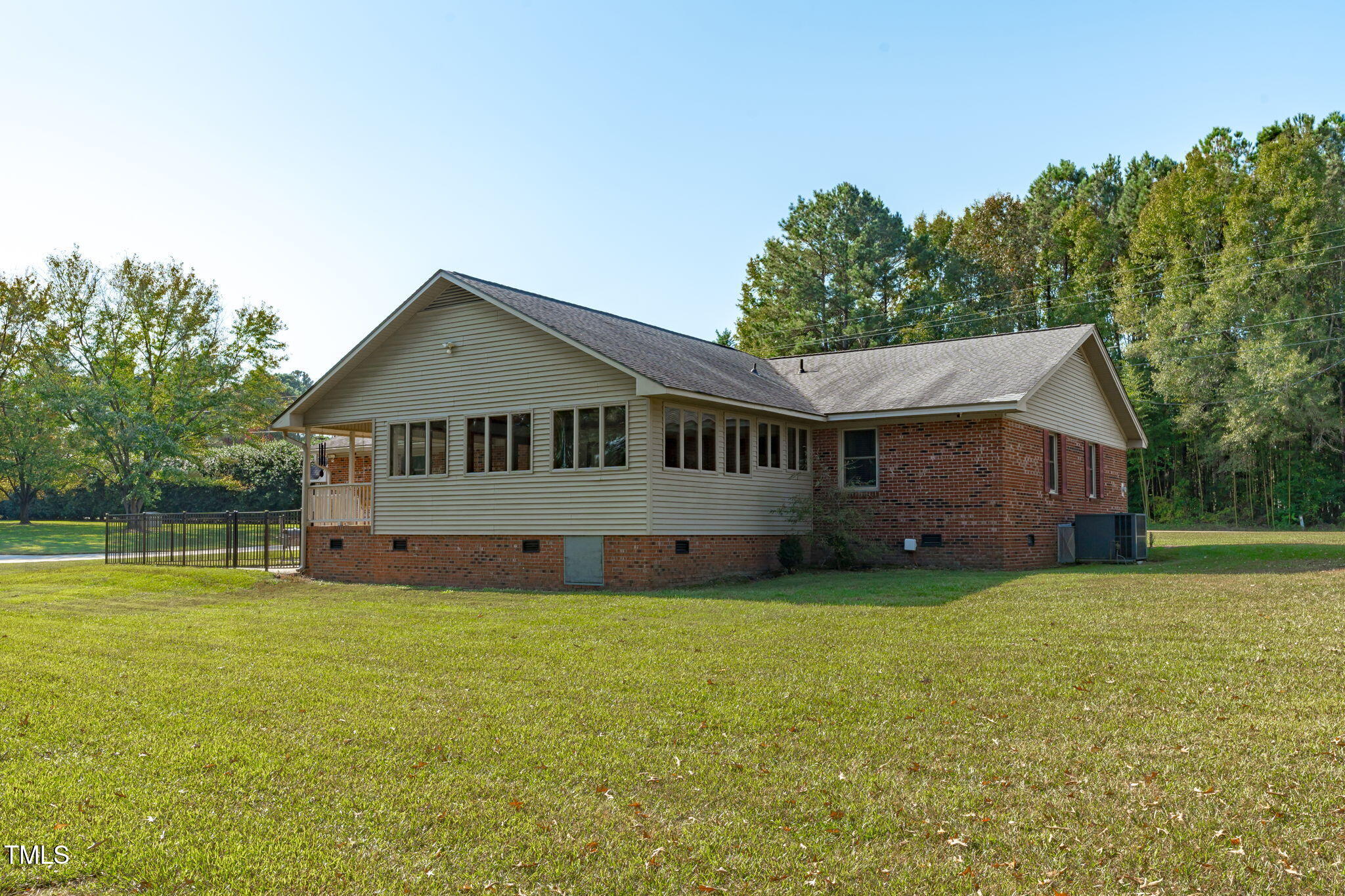 411 Tant Road Zebulon, NC 27597 - Photo 35 of 48 a front view of a house with a garden
