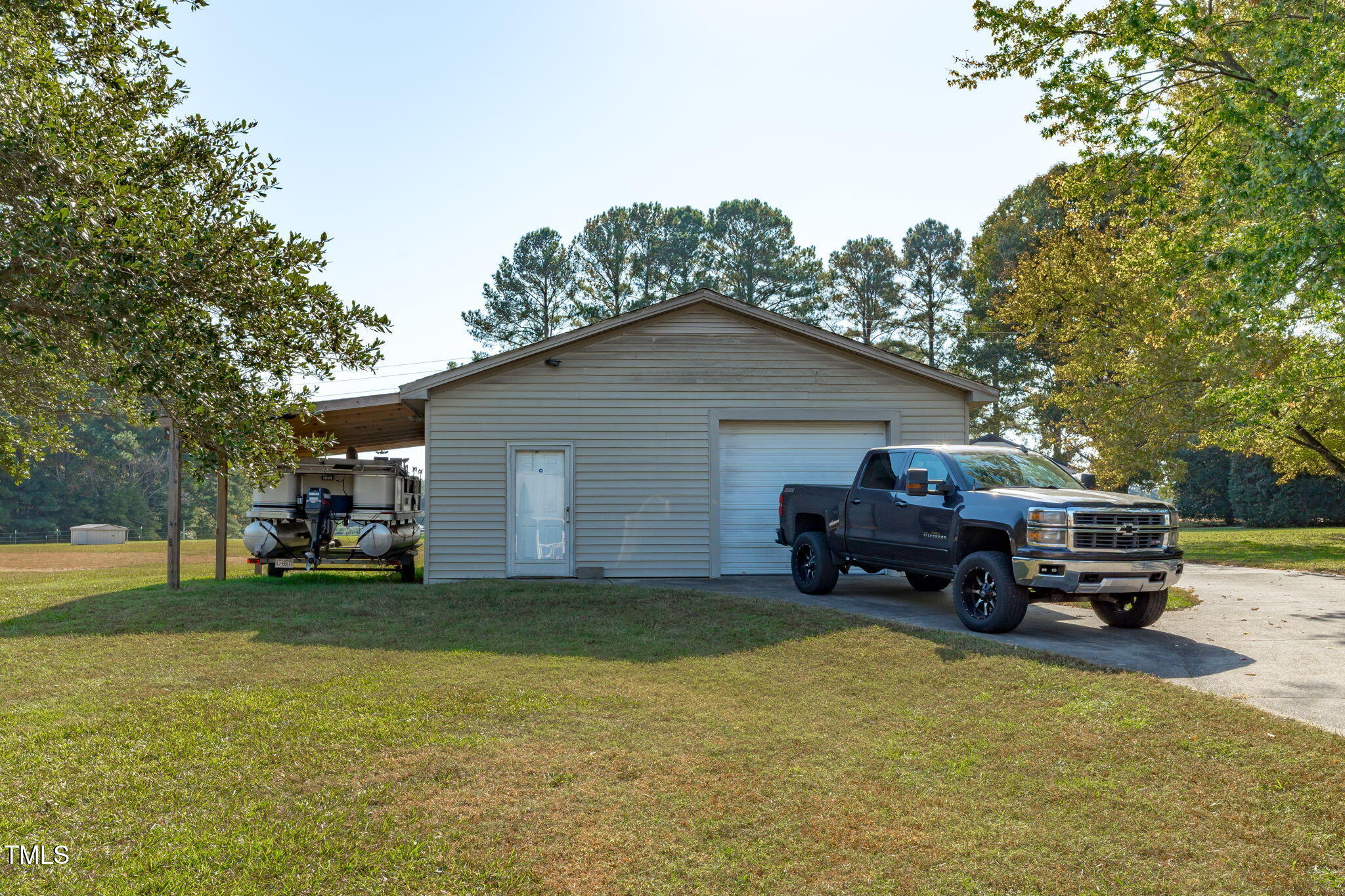 411 Tant Road Zebulon, NC 27597 - Photo 36 of 48 a house view with a garden space