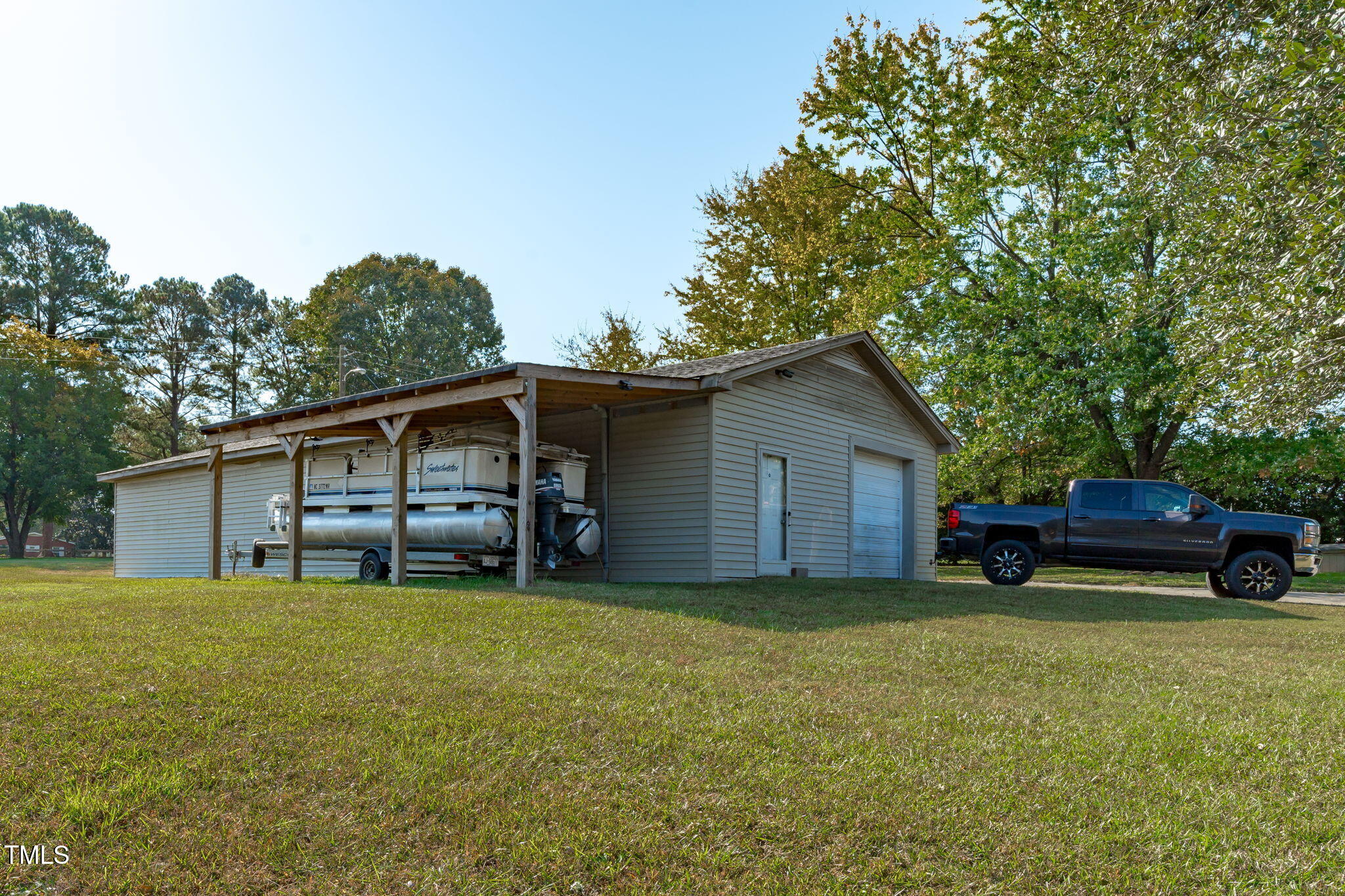 411 Tant Road Zebulon, NC 27597 - Photo 37 of 48 a view of a house with a yard and sitting area