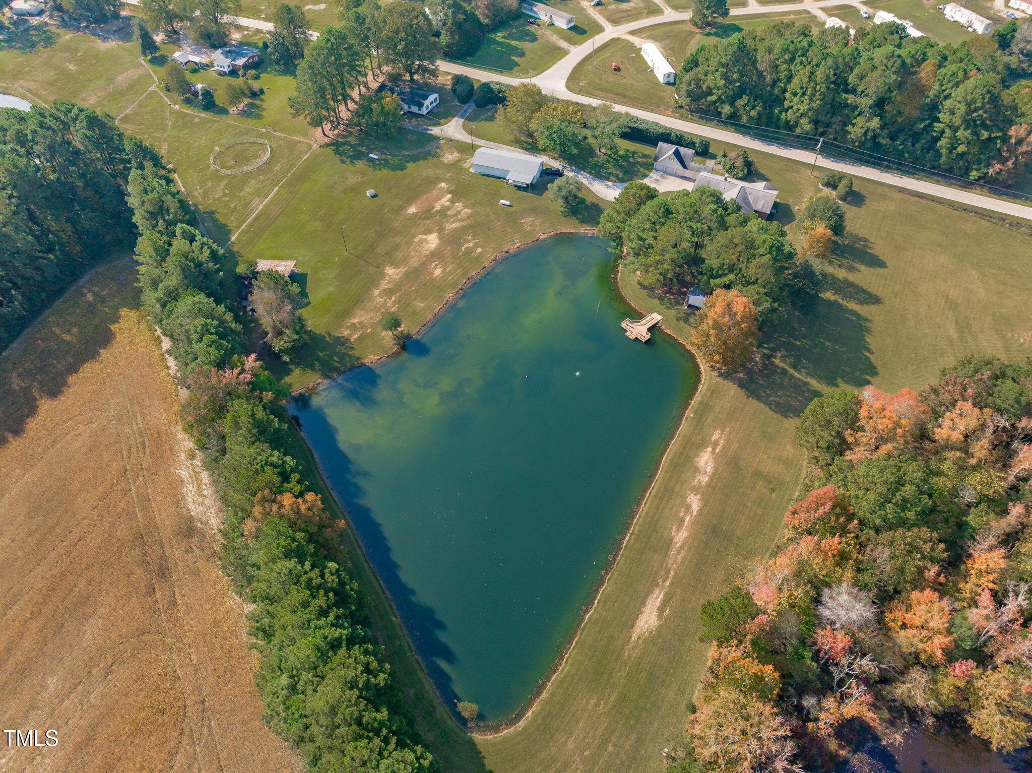 411 Tant Road Zebulon, NC 27597 - Photo 43 of 48 a view of a lake with a yard