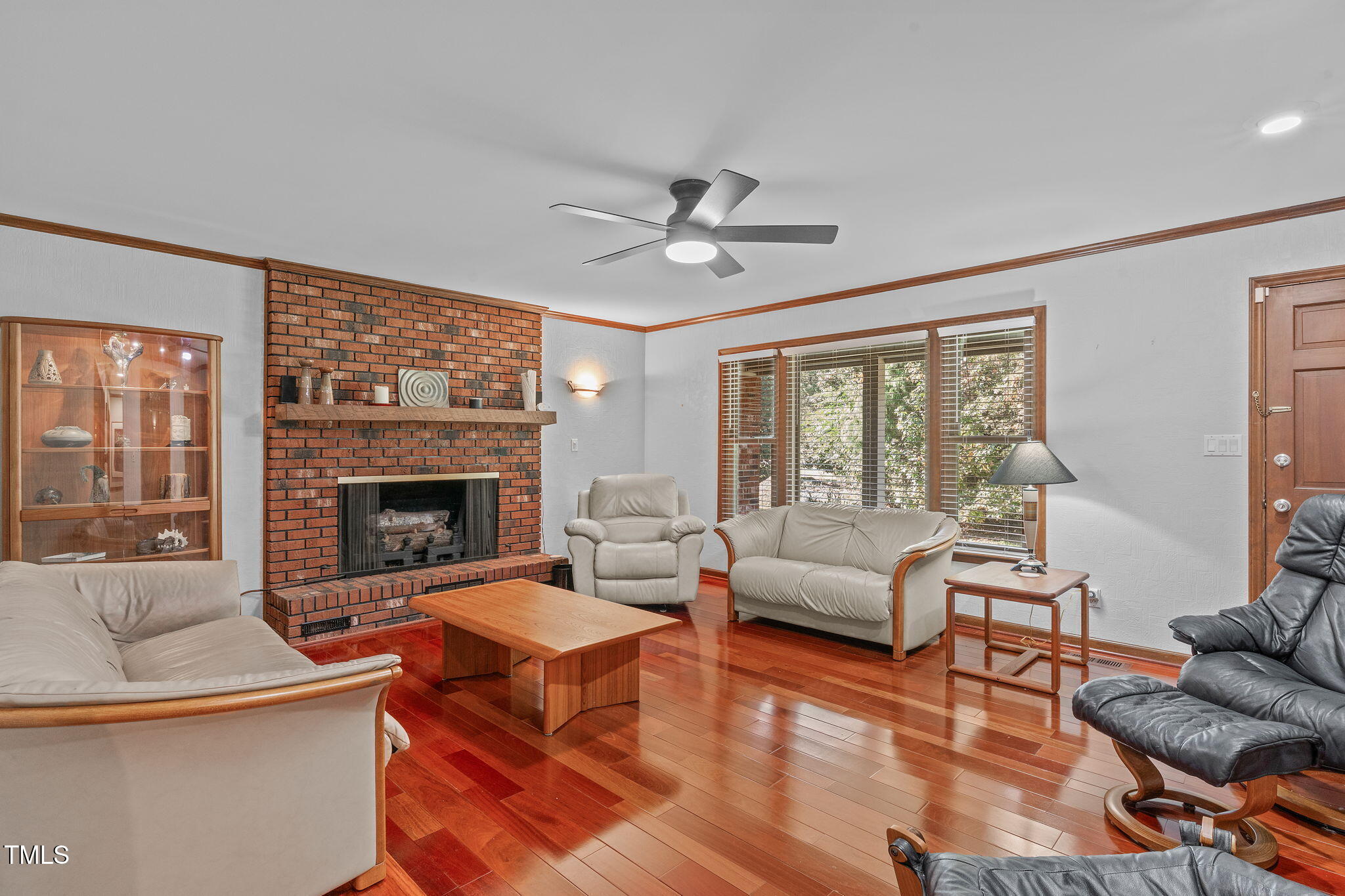 411 Tant Road Zebulon, NC 27597 - Photo 5 of 48 a living room with furniture a fireplace and a floor to ceiling window