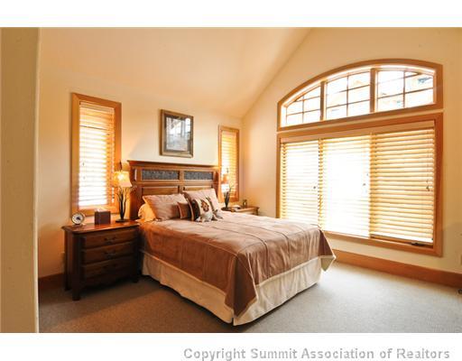 317 Mountain Bluebell Road Keystone, CO 80435 - Photo 14 of 25 a bedroom with a bed and a large window