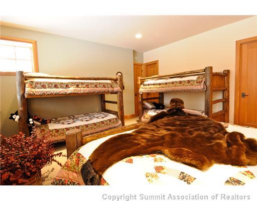 317 Mountain Bluebell Road Keystone, CO 80435 - Photo 17 of 25 a bedroom with a bed and a fireplace