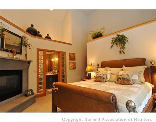 317 Mountain Bluebell Road Keystone, CO 80435 - Photo 19 of 25 a bedroom with a bed and a fireplace