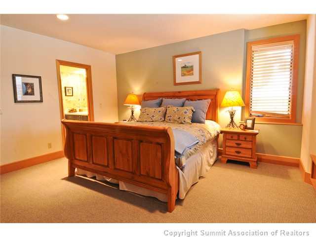 317 Mountain Bluebell Road Keystone, CO 80435 - Photo 22 of 25 a bedroom with a bed and a night stand