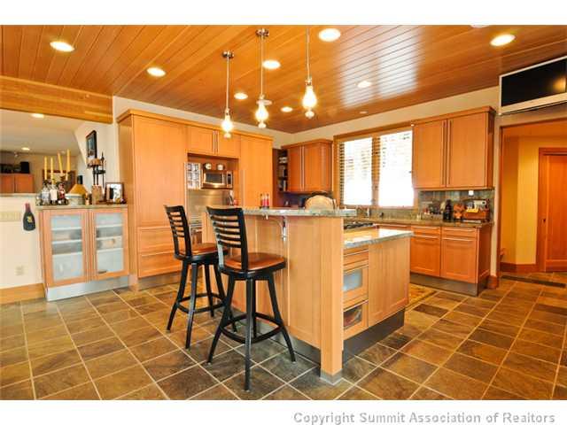 317 Mountain Bluebell Road Keystone, CO 80435 - Photo 8 of 25 a open kitchen with stainless steel appliances granite countertop a stove a sink and cabinets