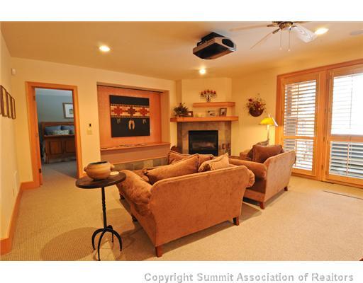 317 Mountain Bluebell Road Keystone, CO 80435 - Photo 10 of 25 a living room with furniture a flat screen tv and a fireplace