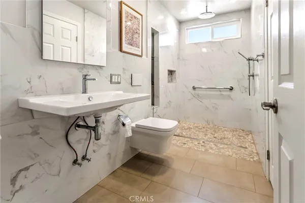 a bathroom with a sink toilet and shower