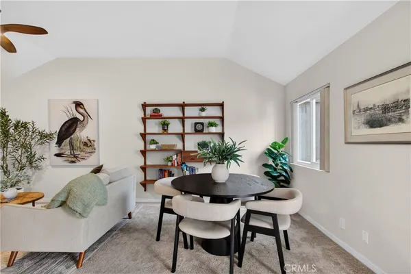 a living room with furniture and flowers