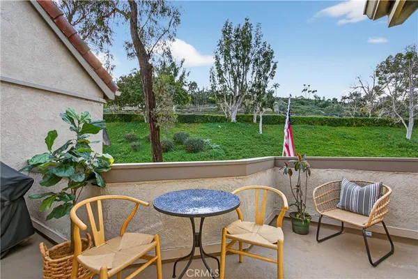 a view of a chairs and table in patio with a yard