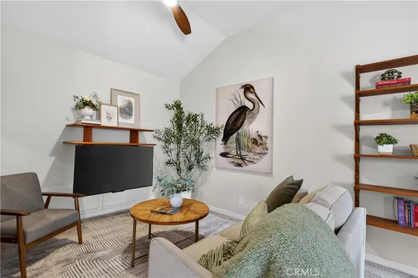 a living room with furniture and a potted plant