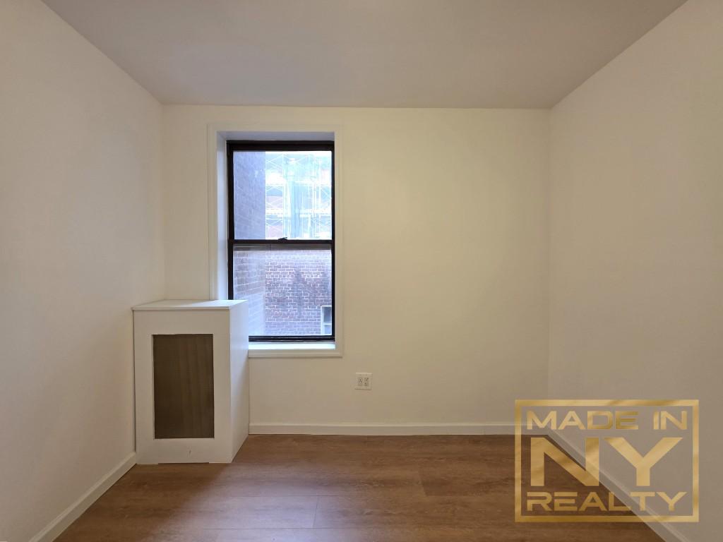 42-14 Union Street, Unit 3C Queens, NY 11355 - Photo 6 of 6 an empty room with wooden floor and windows