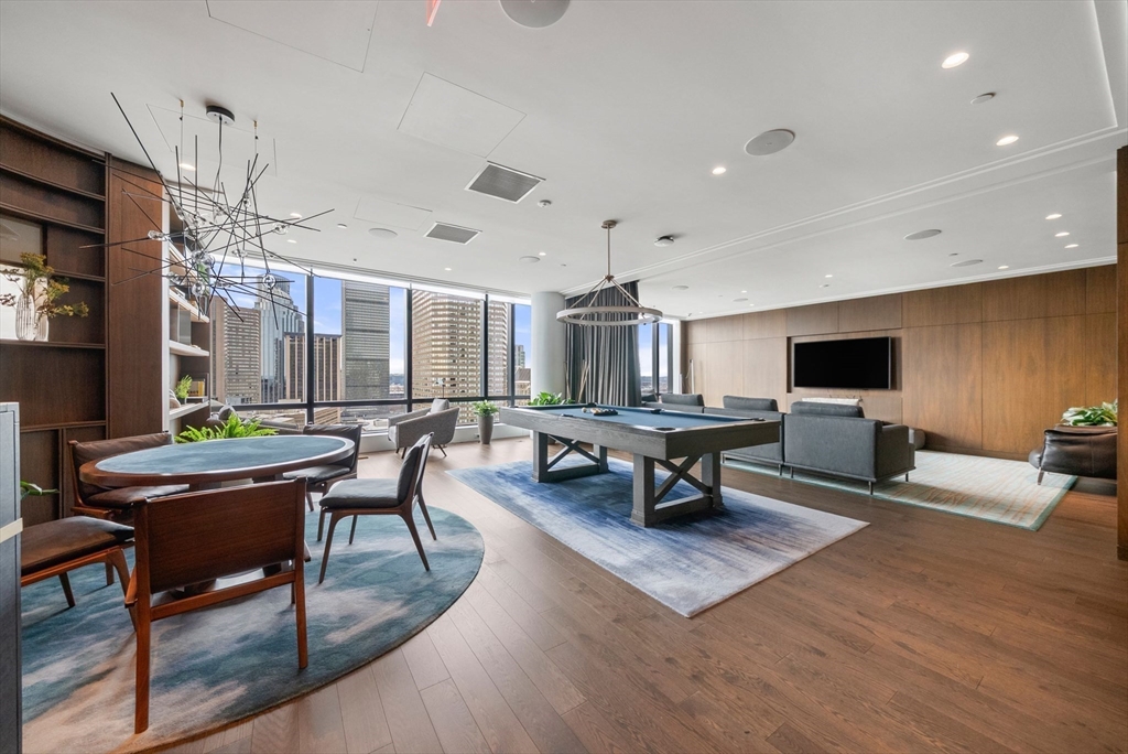 40 Trinity Place, Unit 1518 Boston, MA 02116 - Photo 21 of 25 a living room with furniture a flat screen tv and a table