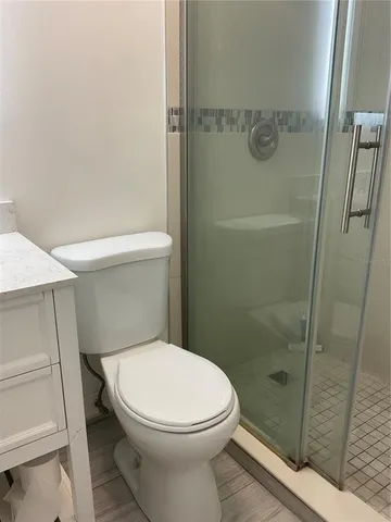 a white toilet sitting next to a bathroom sink