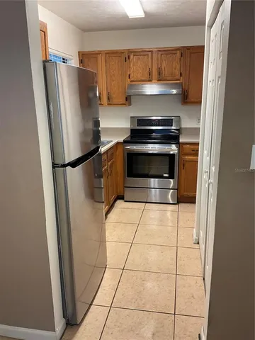 a kitchen with stainless steel appliances a refrigerator and a stove