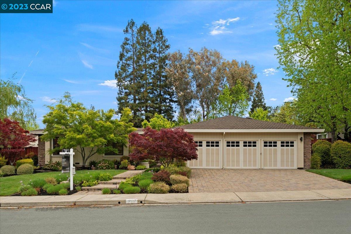 a view of house with outdoor space and garden