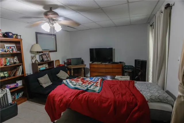 a bedroom with a bed and a bookshelf