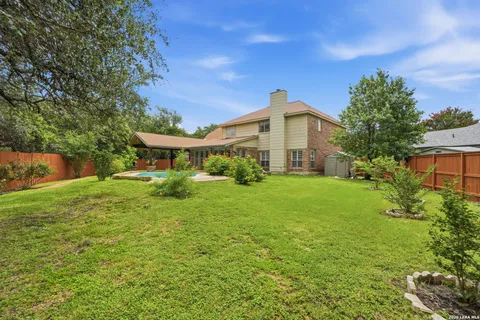 a front view of a house with yard and green space