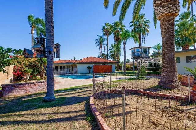 an empty room with windows closet and chandelier fan