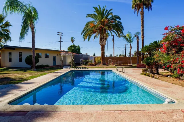 a view of empty room with wooden floor and fireplace
