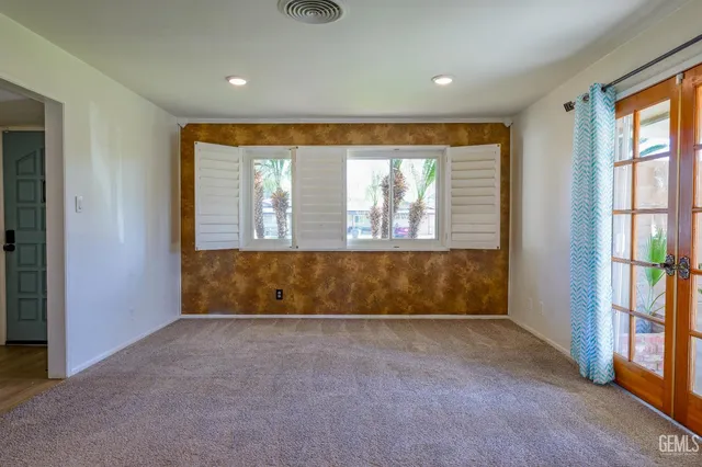 a living room with a fireplace cabinet and a large window