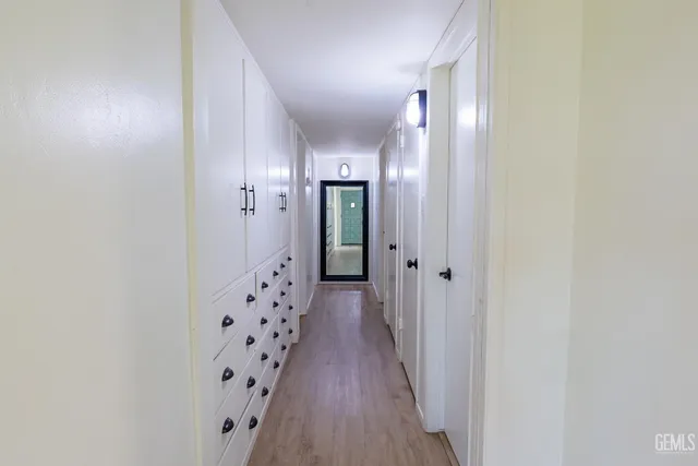 a front view of a house with a yard and potted plants
