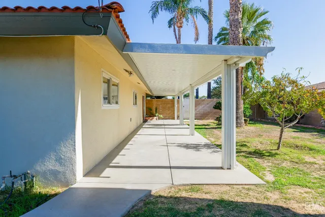 a yellow house with trees in front of it