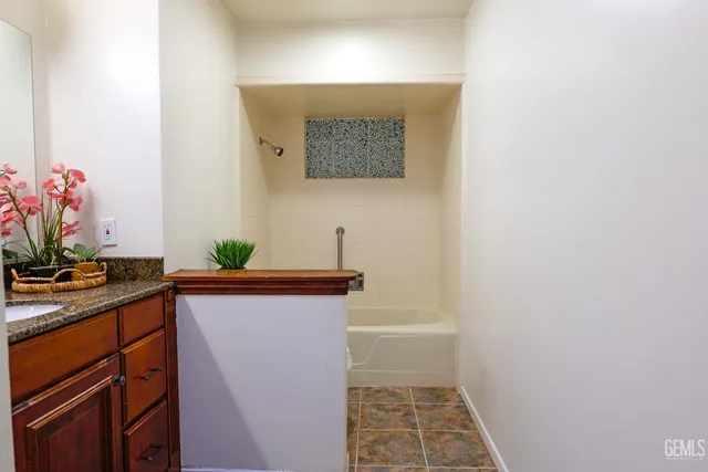 a view of a swimming pool with lawn chairs under an umbrella