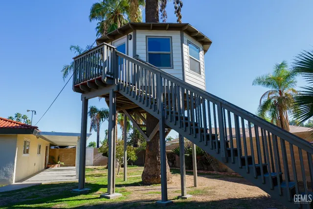a swimming pool with outdoor seating and potted plants