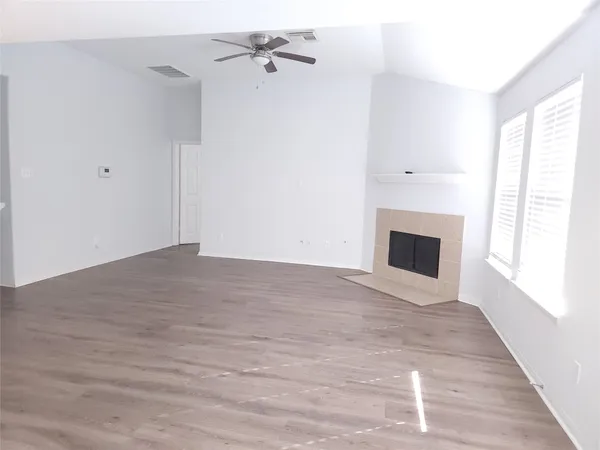 a view of empty room with window and fireplace