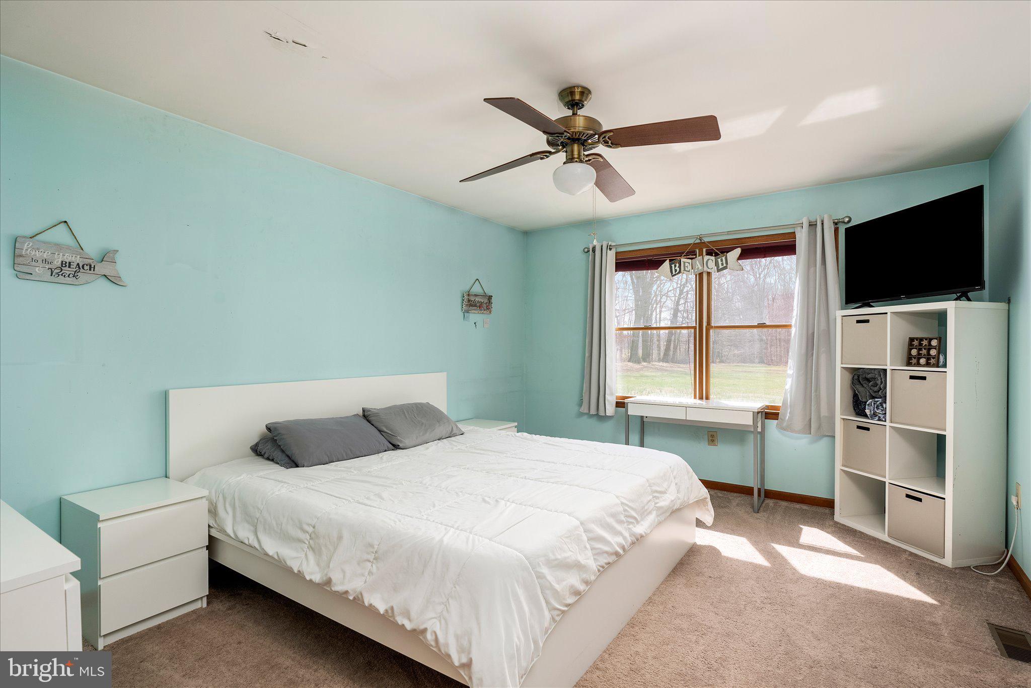 282 Chesterfield Jacobstown Road Wrightstown, NJ 08562 - Photo 27 of 70 a bedroom with a large bed and a flat screen tv