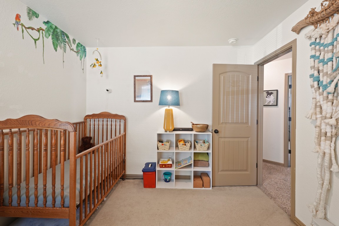 11012 Short Springs Drive Austin, TX 78754 - Photo 19 of 28 a view of a bedroom with wooden shelves