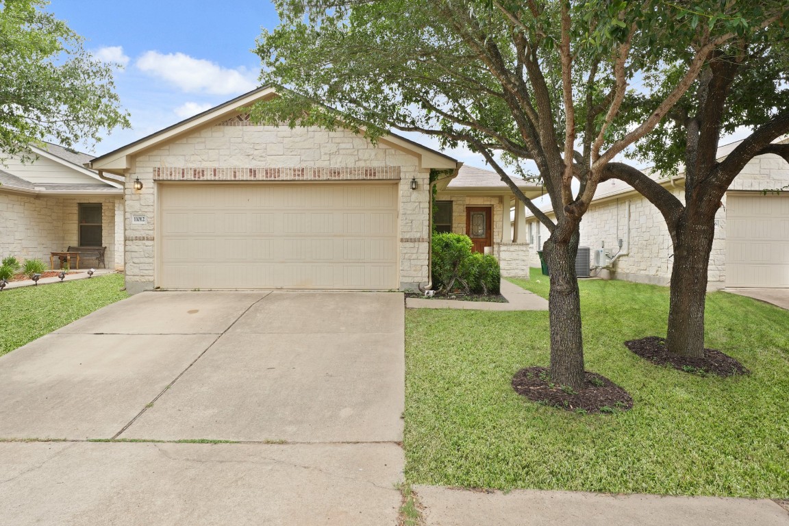 11012 Short Springs Drive Austin, TX 78754 - Photo 2 of 28 a front view of a house with garden