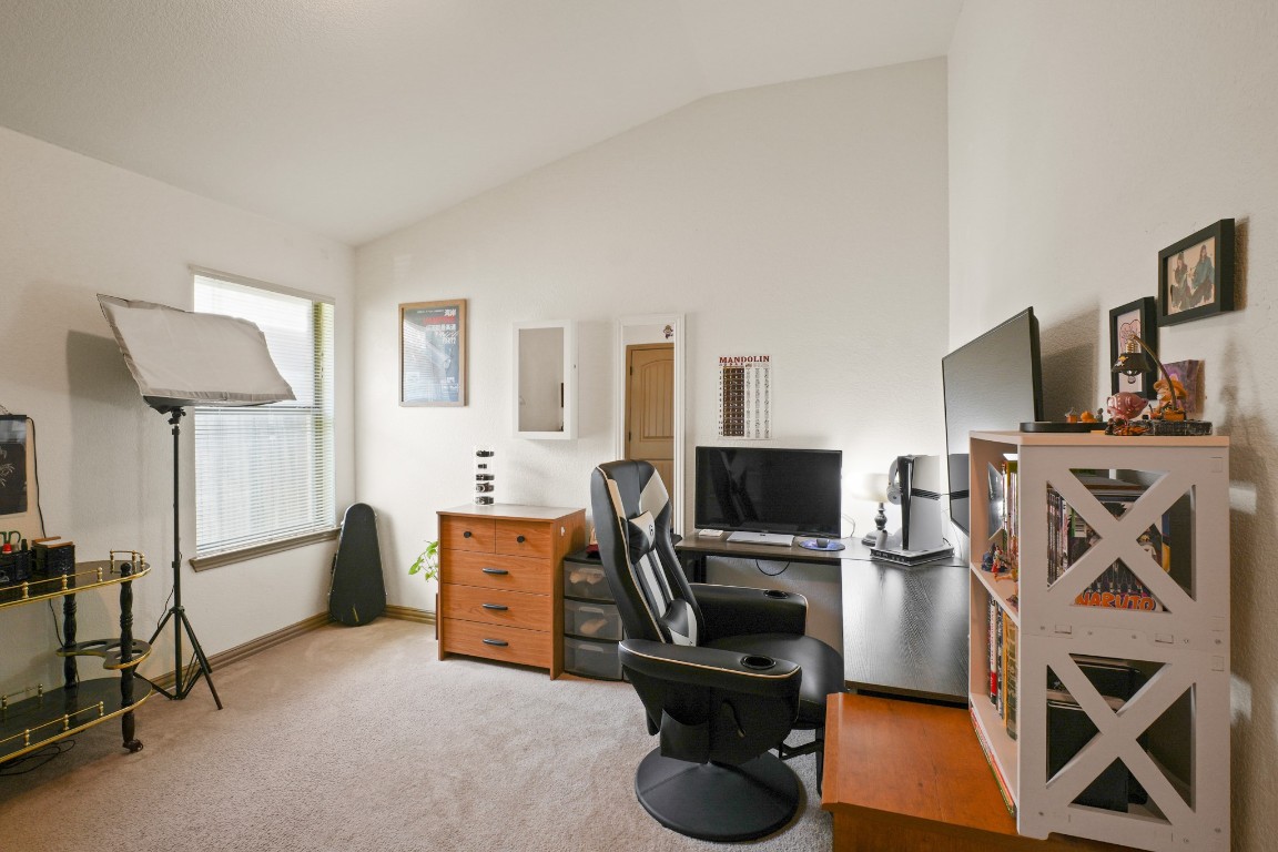 11012 Short Springs Drive Austin, TX 78754 - Photo 22 of 28 a view of a workspace with furniture and a flat screen tv