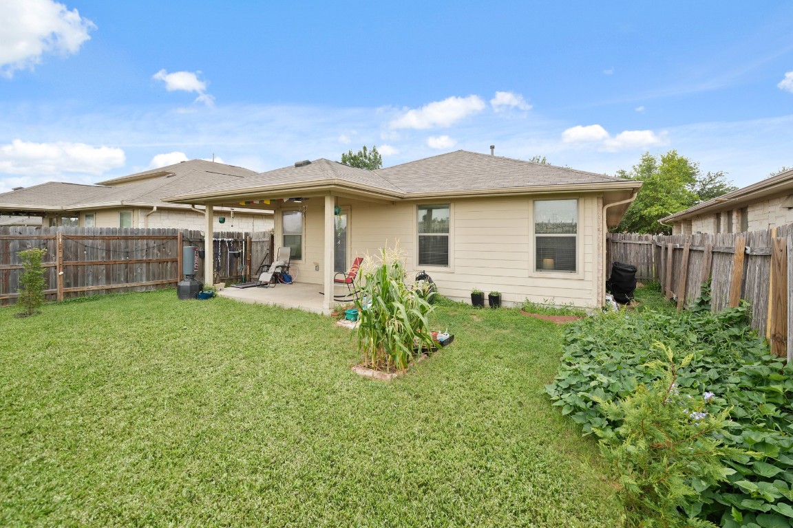 11012 Short Springs Drive Austin, TX 78754 - Photo 24 of 28 a view of a house with backyard and a tree