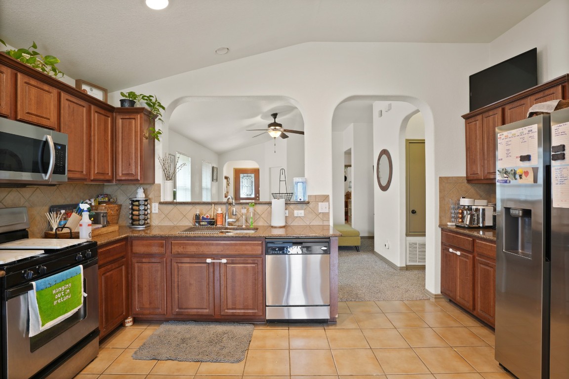 11012 Short Springs Drive Austin, TX 78754 - Photo 8 of 28 a kitchen with stainless steel appliances granite countertop a stove a sink dishwasher and a refrigerator