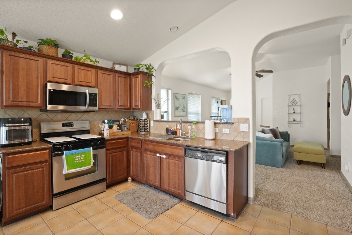 11012 Short Springs Drive Austin, TX 78754 - Photo 9 of 28 a kitchen with a sink a counter top space appliances and cabinets