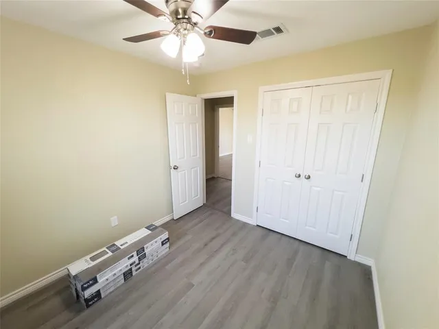 a view of a room with wooden floor
