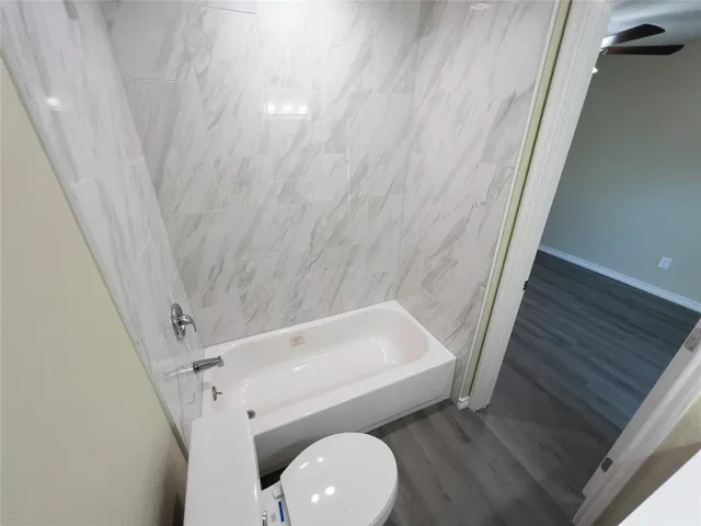 an empty room with a wooden cabinets and a window