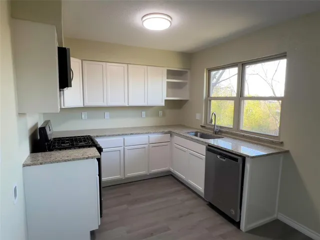 a kitchen with a stove and a sink